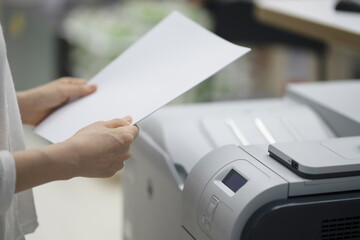 Businesswoman making copies with copy machine