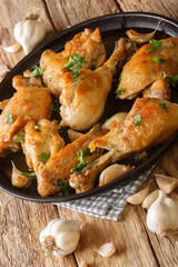 Spanish Garlic Chicken Pollo Al Ajillo close-up on a plate on the table. Vertical