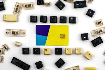  phrase cyber Monday is laid out from the keys of a computer keyboard in the middle there is a credit card around the other buttons from the keyboard randomly lie on a white background of the concept