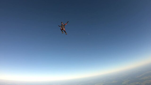 Skydiving. A girl with wings is flying in the sky. Slow motion.