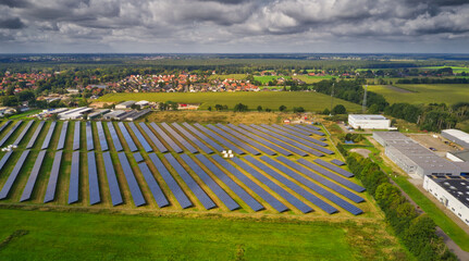 Aerial view of a large solar plant with solar panels on the edge of a village in Germany