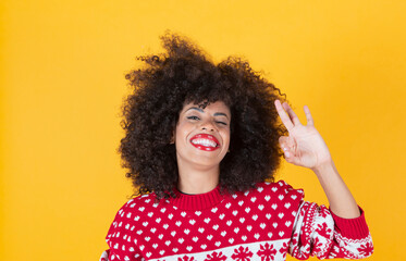 pretty afro christmas woman, ok gesture, yellow background