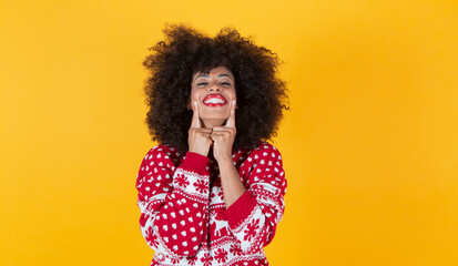 pretty afro christmas woman, fingers in her smile, happy