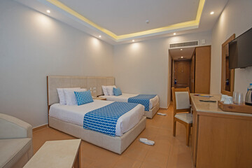 Twin beds in suite of a luxury hotel room