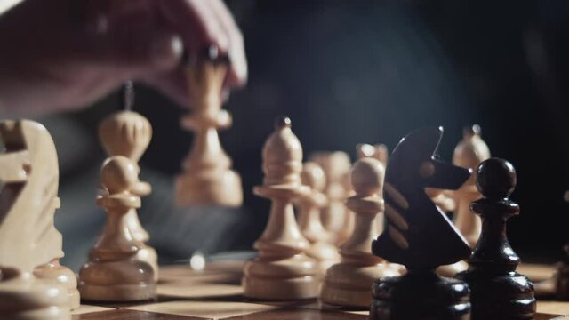 A game of chess and a timid move with a queen. Close-up.