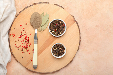 Bowls with black peppercorns and spoon of powder on color background
