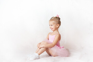 girls - young ballerinas in pink dresses on a light background