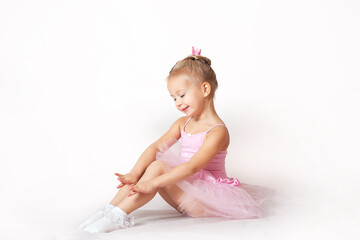 girls - young ballerinas in pink dresses on a light background