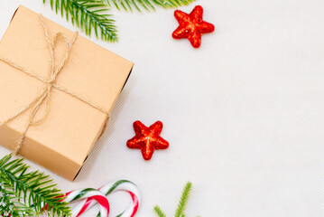 Christmas decor composition white background.Christmas gift box, pine cones, fir branches and star on white background. Flat lay,top view,copy space.