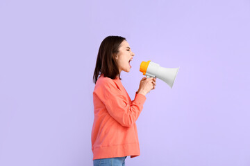Protesting young woman with megaphone on color background