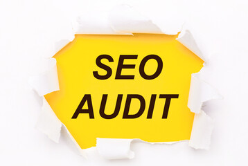 Torn white paper lies on a bright yellow background with the text SEO AUDIT