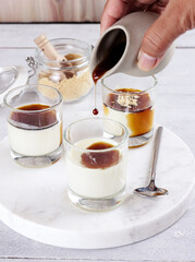 Kurozato panacotta with kuromitsu sauce and sprinkled with roasted kinako powder.  
