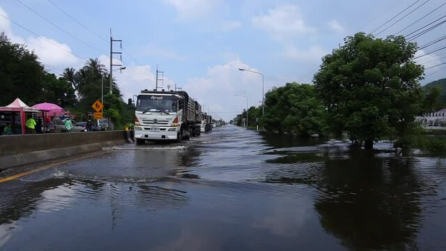 05,Oct,2021,Lopburi Thailand,Cars driving down a flooded street during the worst flooding in decades in Thailand