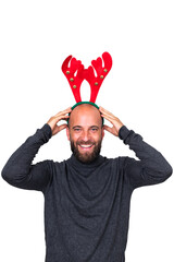 Smiling young caucasian man with Christmas reindeer antlers looking at camera. white background....