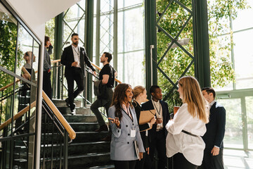 Male and female professional discussing together during networking event at convention center