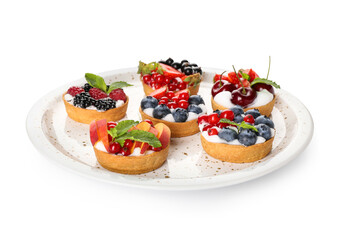 Plate with tasty berry tartlets on white background