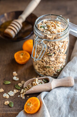 Homemade granola with pumpkin seeds in a glass jar. Dry breakfast cereals. Healthy eating, dieting and nutrition balanced food. Breakfast concept.
