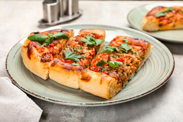 Plate with tasty Turkish Pizza on grunge background