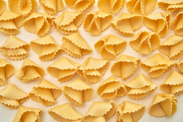 Pattern image of unbacked parts of fortune cookies or raw short pasta, food concept