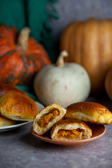 Pumpkin patties. Autumn food. You are on the table. A treat for Halloween. Still life. Sweet pastries with filling. Pie.