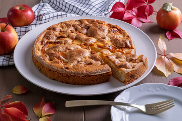 Close-up of a delicious pie with fresh ripe apples. Autumn, harvest, do it yourself, homemade baked goods. Selective focus.