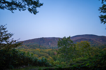 Fototapeta premium 城県栗原市、秋田県湯沢市、雄勝郡東成瀬村、岩手県一関市にある栗駒山近くの湖畔キャンプ場の紅葉の時期の風景 Scenery of the lakeside campground near Mt. Kurikoma in Kurihara City, Castle Prefecture; Yuzawa City, Akita Prefecture; Higashinaruse Village, Oga