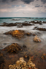 Sea waves crash on the rocks on the shore