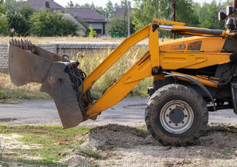 The tractor is working with rubble on the road.