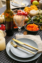 Beautiful table setting with delicious food and bottle of wine