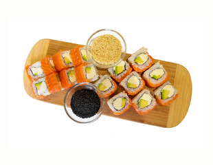Rolls classic Philadelphia with salmon on a wooden board with spices in glass containers