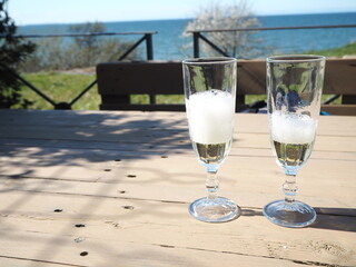 A glass of champagne on the terrace of a summer cafe 