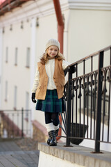 cute girl dressed in autumn clothes on a walk