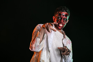 Scary zombie on dark background