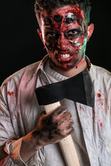Scary zombie with axe on dark background