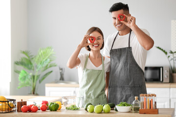 Young couple cooking in kitchen. Vegan Day