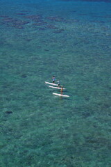 Obraz premium group of SUP stand up paddlers in tropical waters
