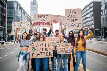 Young people from different culture, fighting for climate change, protesting on the road.