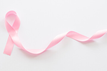 Obraz na płótnie Canvas hand holding pink ribbon on breast cancer awareness day.