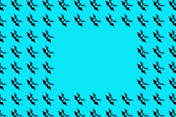 Halloween holiday concept. Pattern from paper bats on a blue background.