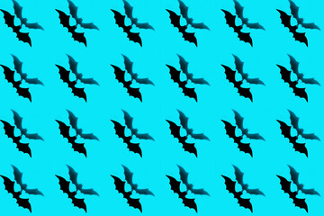 Halloween holiday concept. Pattern from paper bats on a blue background.