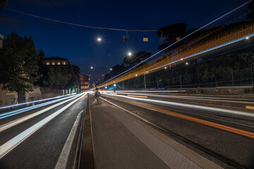 Fototapeta na wymiar Cool long exposure busy traffic neon blue-orange light trails, night view on the street road, Rome, Italy