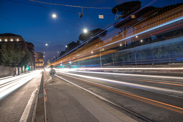 Fototapeta na wymiar Cool long exposure busy traffic neon blue-orange light trails, night view on the street road, Rome, Italy