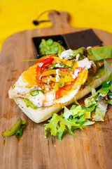 Whole-meal bread sandwich topped with Lyon rosette and butter