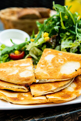 Delicious Mexican beef quesadillas with fresh lettuce and guacamole sauce