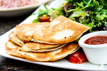 Delicious Mexican beef quesadillas with fresh lettuce and guacamole sauce