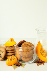 Concept of tasty food with pumpkin cookies on white table