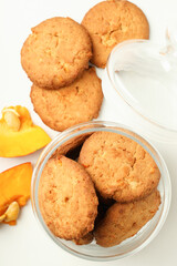 Jar with pumpkin cookies on white background