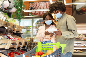 African American Couple Choosing Vegetables Doing Grocery Shopping Together Indoor