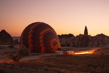 Hot air balloons are getting ready to fly at sunrise in Cappadocia Turkey