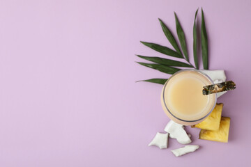 Pina colada cocktail and ingredients on violet background